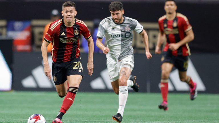 Atlanta United midfielder Matheus Rossetto, left, drives down field past Toronto FC midfielder Jonathan Osorio, center, during the second half of an MLS soccer match, Saturday, March 4, 2023, in Atlanta. (Alex Slitz/AP)