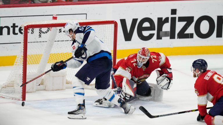 Winnipeg Jets center Mark Scheifele (55) scores the game winning goal against Florida Panthers goaltender Sergei Bobrovsky (72) as Florida Panthers center Sam Bennett (9) defends, during overtime of an NHL hockey game, Saturday, March 11, 2023, in Sunrise, Fla. The Winnipeg Jets defeated the Florida Panthers 5-4 in overtime. (Rebecca Blackwell/AP)