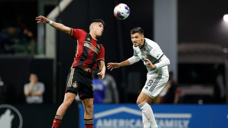 Toronto FC defender Raoul Petretta, right, heads the ball over Atlanta United midfielder Luiz Araújo, left, during the first half of an MLS soccer match, Saturday, March 4, 2023, in Atlanta. (Alex Slitz/AP)