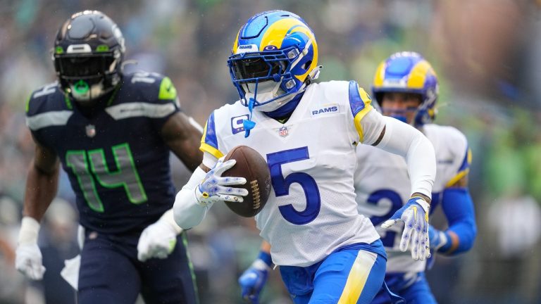 Los Angeles Rams cornerback Jalen Ramsey (5) runs with an intercepted pass past Seattle Seahawks wide receiver DK Metcalf (14) during the first half of an NFL football game Sunday, Jan. 8, 2023, in Seattle. (Abbie Parr/AP)