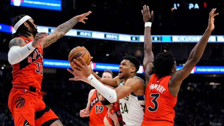 Milwaukee Bucks' Giannis Antetokounmpo is fouled as he drives to the basket against Toronto Raptors' Gary Trent Jr. (33), O.G. Anunoby (3), Jakob Poeltl (19) and Fred VanVleet during the second half of an NBA basketball game. (Aaron Gash/AP)