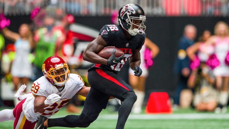 FILE - Atlanta Falcons wide receiver Calvin Ridley (18) runs the ball as Washington Football Team cornerback Kendall Fuller (29) defends during the first half of an NFL football game on Oct. 3, 2021, in Atlanta. (Danny Karnik/AP)