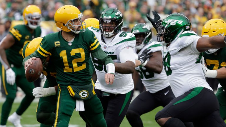 Green Bay Packers quarterback Aaron Rodgers (12) is pressured by the New York Jets defense during the first half of an NFL football game. (Mike Roemer/AP)