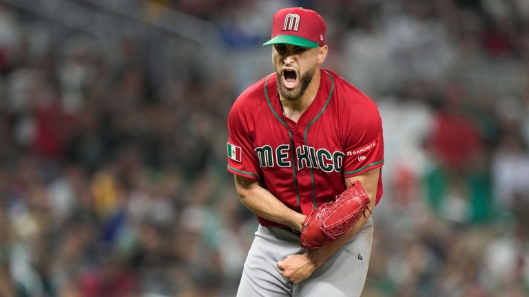 Mexico pitcher Patrick Sandoval reacts after striking out Japan's Munetaka Murakami to end the fourth inning of a World Baseball Classic game. (Wilfredo Lee/AP)