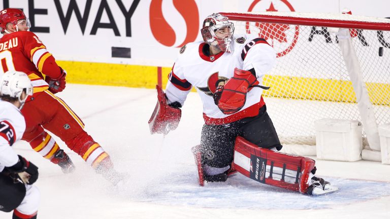 Calgary Flames' Jonathan Huberdeau, left, scores on Ottawa Senators goalie Kevin Mandolese during second period NHL hockey action in Calgary. (Larry MacDougal/CP)