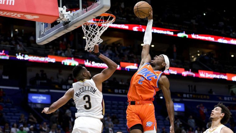 Oklahoma City Thunder guard Shai Gilgeous-Alexander (2) dunks over New Orleans Pelicans guard CJ McCollum (3) during the fourth quarter of an NBA basketball game. (Derick Hingle/AP)