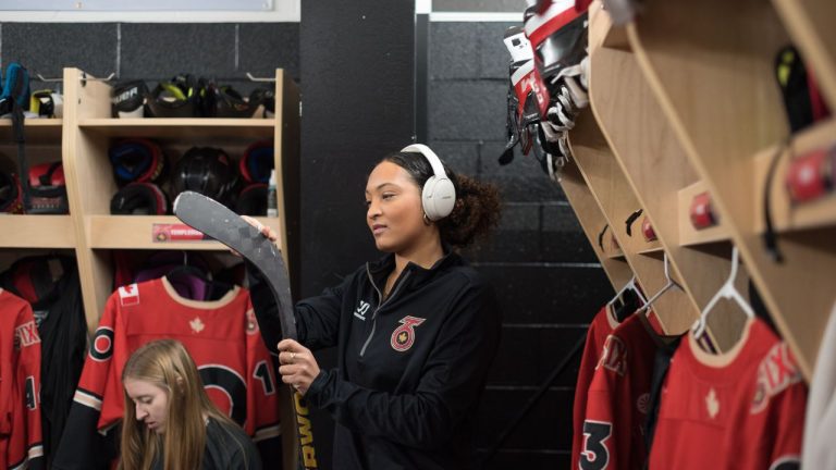 Saroya Tinker of the Toronto Six of the Premier Hockey Federation listens to music while prepping her stick before a home game against the Connecticut Whale, at Canlan Sports at York University in Toronto, on Saturday, January 21, 2023. (Tijana Martin/CP Photo)