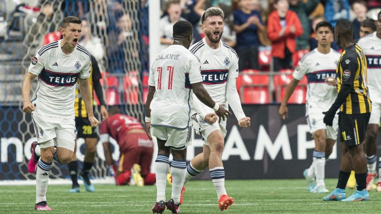 Vancouver Whitecaps FC's Tristan Blackmon (right) celebrates with teammates Ranko Veselinovic (left) and Cristian Dajome after scoring a goal against Real Espana during first half CONCACAF Champions League soccer action in Vancouver, B.C. (Rich Lam/CP)
