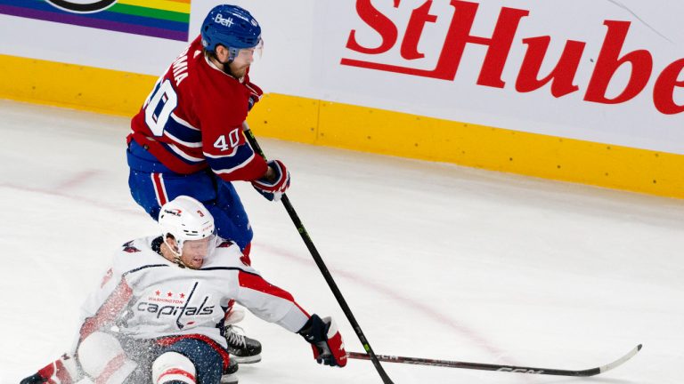 Washington Capitals' Nick Jensen (3) goes down on the ice as he battles Montreal Canadiens' Joel Armia (40) for the puck during first period NHL hockey action in Montreal, Thursday, April 6, 2023. (Peter McCabe/CP)