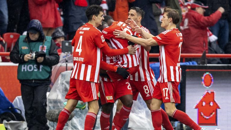 Berlin's Sheraldo Becker, second from left, celebrates with teammates after scoring during the German Bundesliga soccer match between Union Berlin and Stuttgart, at the Alte Forsterei Stadium, in Berlin, Saturday, April 1, 2023. (Andreas Gora/dpa via AP)