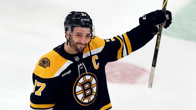 Boston Bruins' Patrice Bergeron raises his stick to the fans after losing to the Florida Panthers in overtime during Game 7 of an NHL hockey Stanley Cup first-round playoff series, Sunday, April 30, 2023, in Boston. (Michael Dwyer/AP)