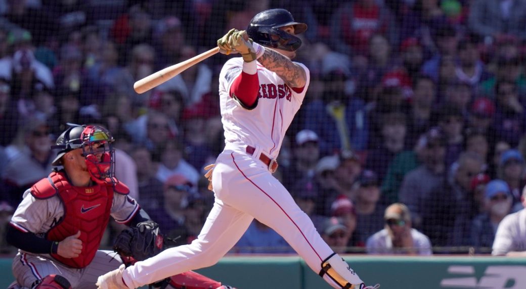 Boston Red Sox's Jarren Duran has his photo taken with a member of