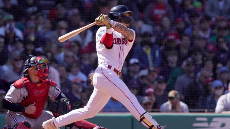 Boston Red Sox's Jarren Duran hits a two-run double in front of Minnesota Twins' Christian Vazquez, left, in the third inning of a baseball game, Thursday, April 20, 2023, in Boston. (Steven Senne/AP)