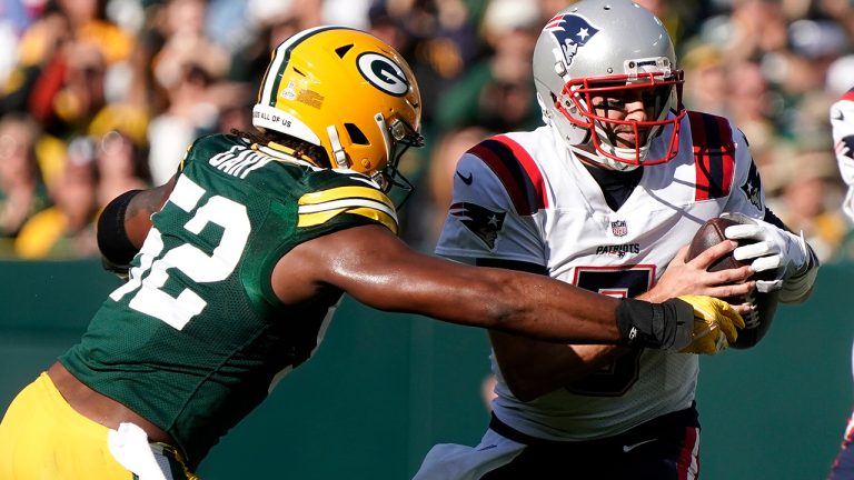 New England Patriots quarterback Brian Hoyer (5) is sacked by Green Bay Packers linebacker Rashan Gary (52) during the first half of an NFL football game, Sunday, Oct. 2, 2022, in Green Bay, Wis. (Morry Gash/AP)