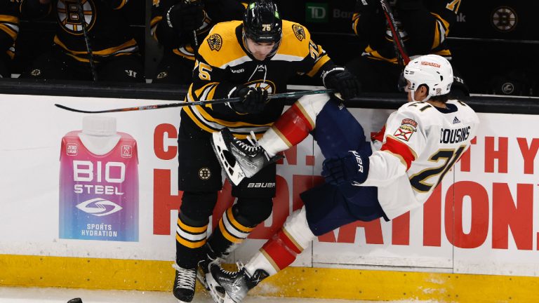 Boston Bruins defenseman Connor Clifton, left, checks Florida Panthers' Nick Cousins off the puck during the first period of Game 1 of an NHL hockey playoff series Monday, April 17, 2023, in Boston. (Winslow Townson/AP)