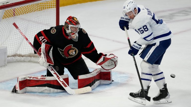 Toronto Maple Leafs left wing Michael Bunting (58) tries to deflect a shot infant of Ottawa Senators goaltender Mads Sogaard during second period NHL action in Ottawa, Saturday, March 18, 2023. (Adrian Wyld/CP)