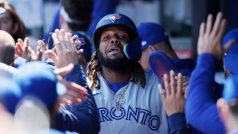 Toronto Blue Jays first baseman Vladimir Guerrero Jr. celebrates in the dugout after scoring off a Matt Chapman double during the first inning of a baseball game in Kansas City, Mo., Thursday, April 6, 2023. (Colin E. Braley/AP) 