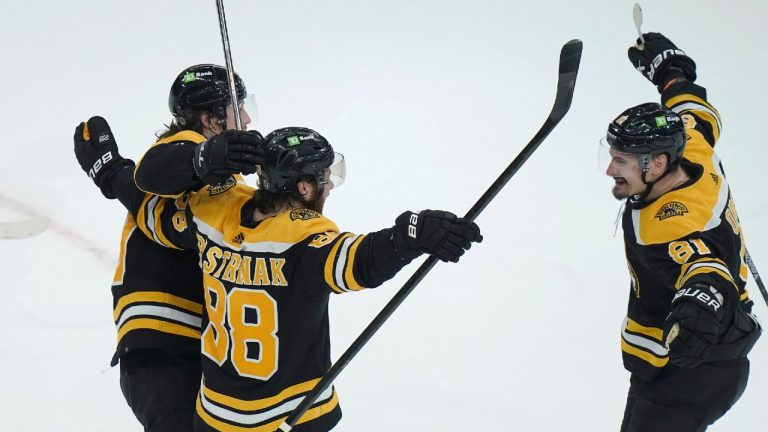 Boston Bruins right wing David Pastrnak (88) celebrates with left wing Tyler Bertuzzi (59) and defenseman Dmitry Orlov (81) after scoring during overtime in an NHL hockey game against the Toronto Maple Leafs, Thursday, April 6, 2023, in Boston. (Steven Senne/AP)