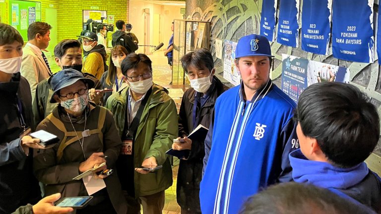 Trevor Bauer, second right, listens to his interpreter as they were taking questions from reporters after a warm-up game in Hiratsuka, southwest of Tokyo, Japan, Saturday, April 22, 2023. Bauer on Saturday pitched his second game against minor-league competition as he prepares for his debut with the Yokohama DeNA BayStars. (Stephen Wade/AP) 