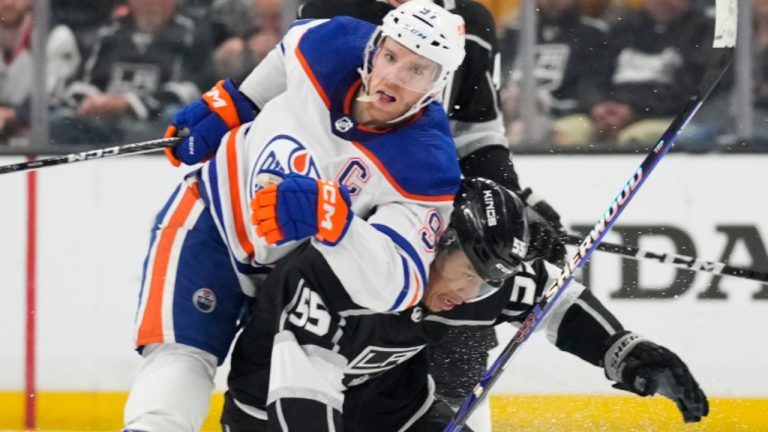 Edmonton Oilers centre Connor McDavid (97) knocks down Los Angeles Kings center Quinton Byfield (55) during the second period of Game 4 of an NHL hockey Stanley Cup first-round playoff series hockey game Sunday, April 23, 2023, in Los Angeles. (Ashley Landis/AP) 