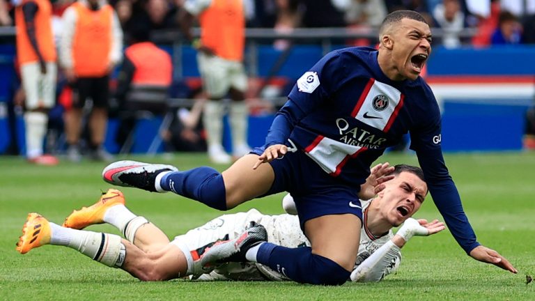 PSG's Kylian Mbappe is fouled by Lorient's Enzo Le Fee during the French League One soccer match between Paris Saint-Germain and Lorient, at the Parc des Princes stadium in Paris, Sunday, April 30, 2023. (Aurelien Morissard/AP) 