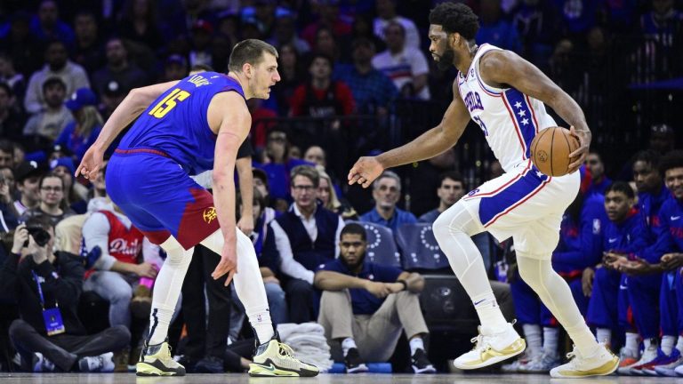 Philadelphia 76ers' Joel Embiid, right, dribbles the ball as Denver Nuggets' Nikola Jokic defends during the first half of an NBA basketball game, Saturday, Jan. 28, 2023, in Philadelphia. (Derik Hamilton/AP)