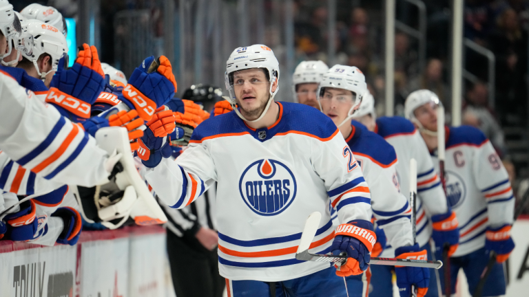 Edmonton Oilers centre Mattias Janmark, right, is congratulated as he passes the team box after scoring a goal in the third period of an NHL hockey game against the Colorado Avalanche, Sunday, Feb. 19, 2023, in Denver. (AP)