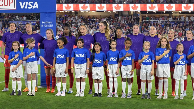 Canada players wear purple shirts with "Enough is Enough" written on them during the Canadian national anthem before the team's SheBelieves Cup women's soccer match against the United States, Thursday, Feb. 16, 2023, in Orlando, Fla. (Phelan M. Ebenhack/AP)