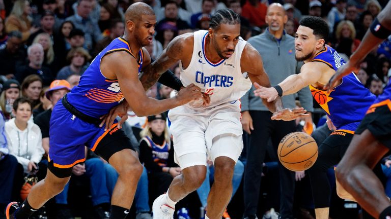 Phoenix Suns' Chris Paul, left, and Devin Booker, right, double-team Los Angeles Clippers' Kawhi Leonard during the first half of an NBA basketball game Thursday, Feb. 16, 2023, in Phoenix. (Darryl Webb/AP)