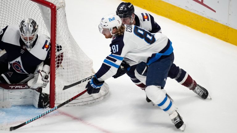 Winnipeg Jets left wing Kyle Connor, front right, drives past Colorado Avalanche right wing Logan O'Connor, back right, to shoot against Avalanche goaltender Alexandar Georgiev in the third period of an NHL hockey game. (David Zalubowski/AP)