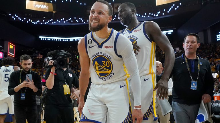 Golden State Warriors guard Stephen Curry (30) celebrates with forward Draymond Green after the Warriors defeated the Sacramento Kings in Game 4 in the first round of the NBA basketball playoffs in San Francisco, Sunday, April 23, 2023. (Jeff Chiu/AP)