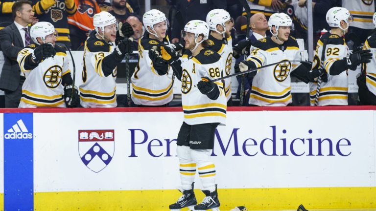 Boston Bruins' David Pastrnak, centre, celebrates his third goal of the game with teammates during the third period of an NHL hockey game against the Philadelphia Flyers, Sunday, April 9, 2023, in Philadelphia. (Chris Szagola/AP)