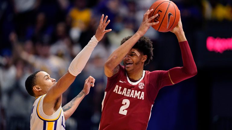 Alabama forward Darius Miles (2) tries to pass around LSU guard Xavier Pinson in the second half an NCAA college basketball game in Baton Rouge, La., Saturday, March 5, 2022. (Gerald Herbert/AP)