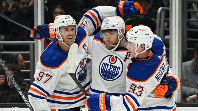 Edmonton Oilers center Leon Draisaitl, center, celebrates his goal with center Connor McDavid, left, and center Ryan Nugent-Hopkins during the second period of an NHL hockey game Tuesday, April 4, 2023, in Los Angeles. (Mark J. Terrill/AP)