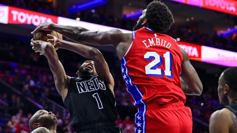 Philadelphia 76ers' Joel Embiid (21) blocks a shot by Brooklyn Nets' Mikal Bridges (1) in the first half during Game 1 in the first round of the NBA basketball playoffs, Saturday, April 15, 2023, in Philadelphia. (Derik Hamilton/AP)