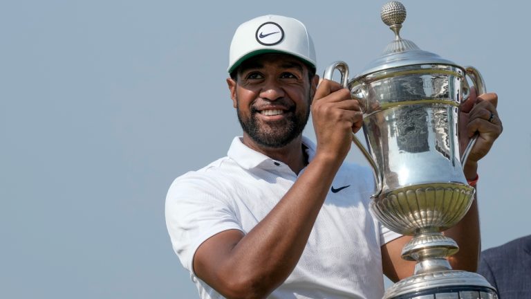 Tony Finau of the United States holds the championship trophy after his victory in the final round of the Mexico Open golf tournament in Puerto Vallarta, Mexico, Sunday, April 30, 2023. (Moises Castillo/AP)