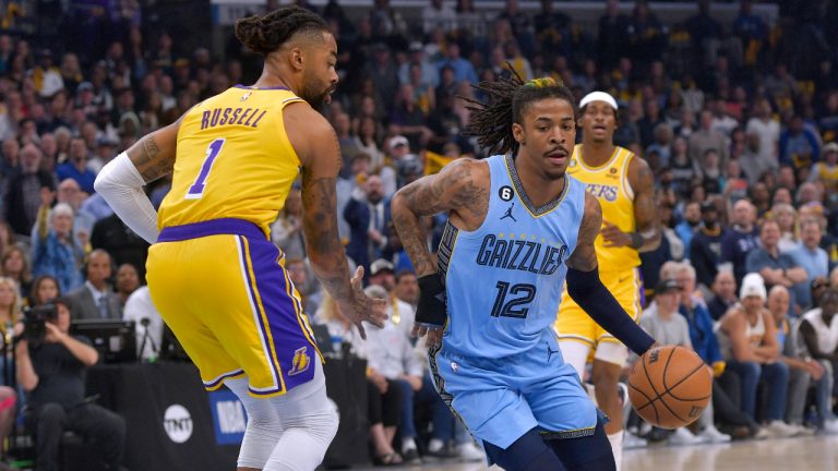 Memphis Grizzlies guard Ja Morant (12) drives past Los Angeles Lakers guard D'Angelo Russell (1) during the first half of Game 5 in a first-round NBA basketball playoff series Wednesday, April 26, 2023, in Memphis, Tenn. (Brandon Dill/AP)