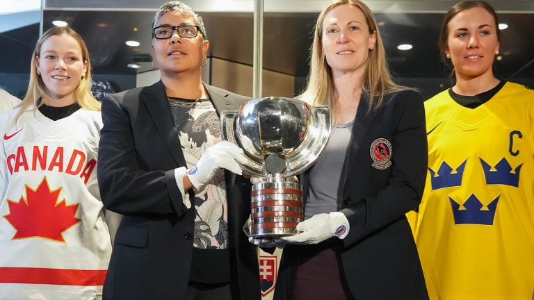 Team Canada’s Sarah Fillier, left, Angela James, second left, HHOF 2010, GM of Toronto Six and Jayna Hefford, second right, HHOF 2018, Chairperson, PWHPA and Team Sweden’s Anna Kjellbin pose with a trophy at the Hockey Hall of Fame in Toronto on Tuesday, April 4, 2023. (Nathan Denette/CP)