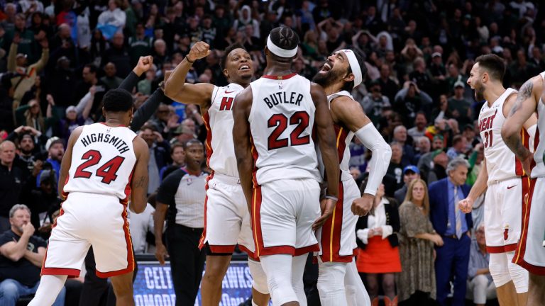 Miami Heat's Jimmy Butler (22), Kyle Lowry, center left, and Gabe Vincent center right, react at the end of overtime against the Milwaukee Bucks in Game 5 of a first-round NBA basketball playoff series Wednesday, April 26, 2023, in Milwaukee. The Heat won 128-126, eliminating the Bucks from the playoffs. (Jeffrey Phelps/AP)