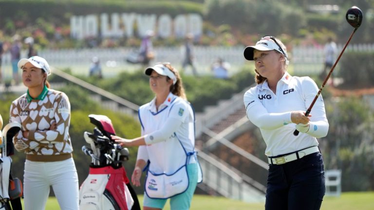 Brooke Henderson hits from the 16th tee while Minjee Lee watches during the first round of the LPGA LA Championship golf tournament at Wilshire Country Club Thursday, April 27, 2023, in Los Angeles. (Marcio Jose Sanchez/AP Photo)