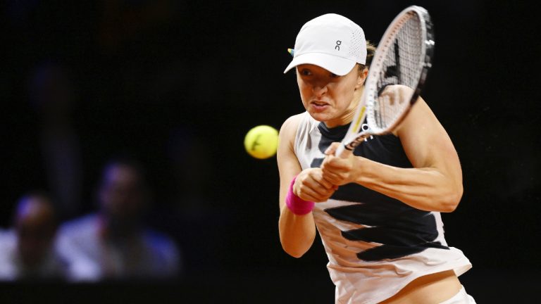 Poland's Iga Swiatek returns a ball to Tunisia's Ons Jabeur during the WTA women's singles semifinal match at Porsche Arena, Stuttgart, Germany, Saturday April 22, 2023. (Marijan Murat/dpa via AP)