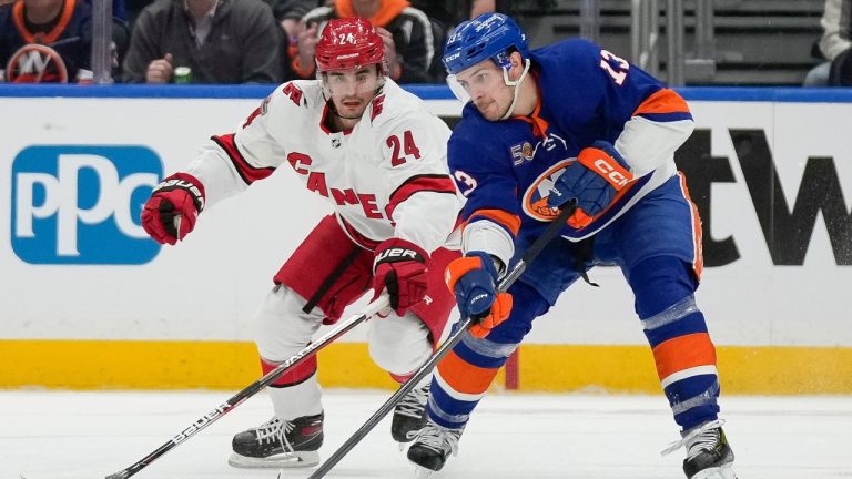 New York Islanders centre Mathew Barzal and Carolina Hurricanes centre Seth Jarvis vie for control of the puck during the first period Game 3 in an NHL hockey Stanley Cup first-round playoff series Friday, April 21, 2023, in Elmont, N.Y. (Bryan Woolston/AP Photo)