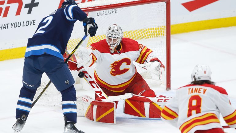 Calgary Flames goaltender Jacob Markstrom (25) saves the shot from Winnipeg Jets' Nino Niederreiter (62) during second period NHL action in Winnipeg, Wednesday, April 5, 2023. (John Woods/CP)