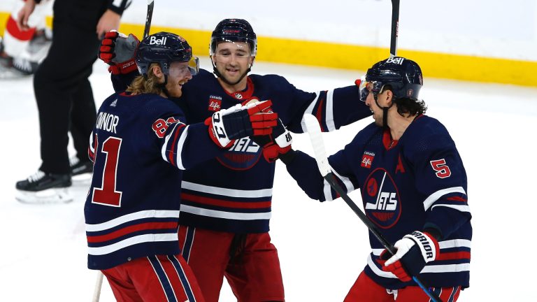 Winnipeg Jets' Kyle Connor (81), Neal Pionk (4) and Brenden Dillon (5) celebrate Connor’s goal against the Detroit Red Wings during first period NHL action in Winnipeg, Friday, March 31, 2023. (John Woods/CP)