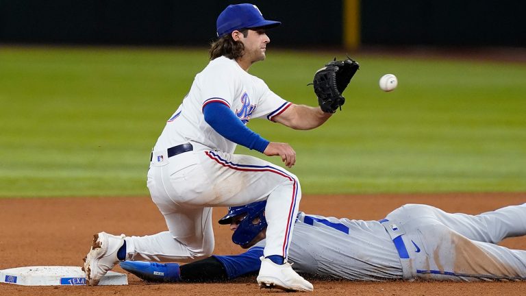 Kansas City Royals' Bobby Witt Jr. dives stealing second base against Texas Rangers shortstop Josh Smith (47) during the seventh inning of a baseball game in Arlington, Texas, Wednesday, April 12, 2023. (LM Otero/AP)