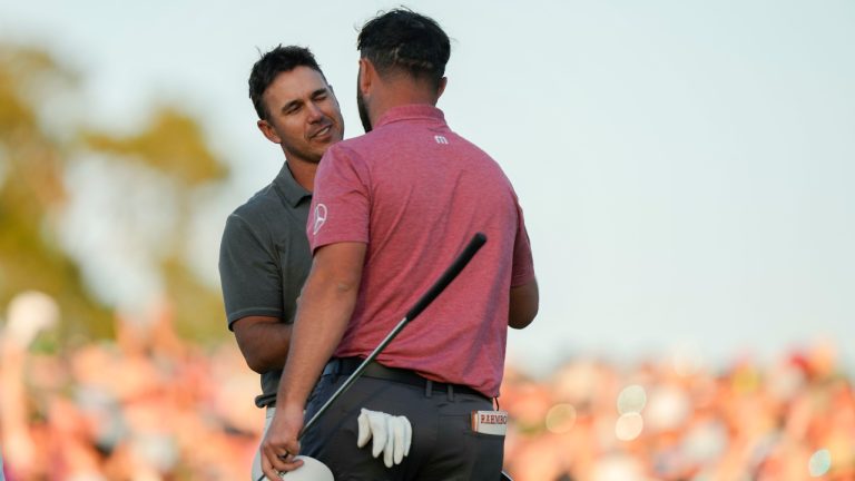 Brooks Koepka, left, congratulates Jon Rahm, of Spain, on Rahm's winning the Masters golf tournament at Augusta National Golf Club on Sunday, April 9, 2023, in Augusta, Ga. (Charlie Riedel/AP)