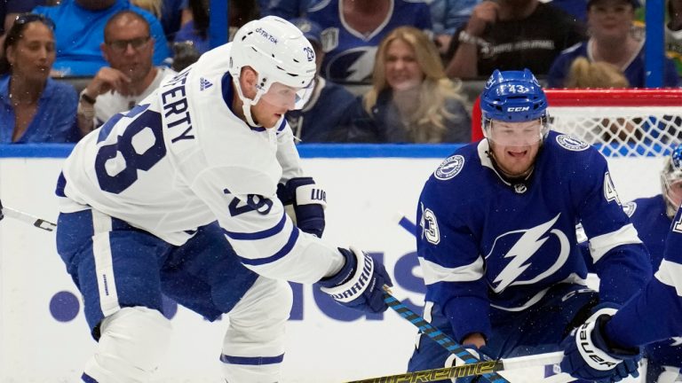 Toronto Maple Leafs center Sam Lafferty (28) tries to get between Tampa Bay Lightning defenceman Darren Raddysh (43) and centre Steven Stamkos (91) during the second period in Game 3 of an NHL hockey Stanley Cup first-round playoff series Saturday, April 22, 2023, in Tampa, Fla. (Chris O'Meara/AP)