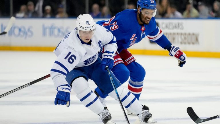 Toronto Maple Leafs right wing Mitchell Marner and New York Rangers defenceman K'Andre Miller battle for the puck during the first period of an NHL hockey game, Thursday, April 13, 2023, in New York. (John Minchillo/AP Photo)