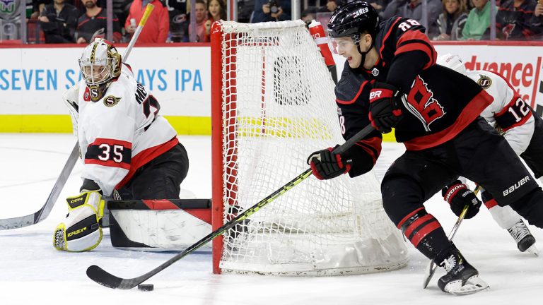 Ottawa Senators goaltender Leevi Merilainen (35) stops a shot by Carolina Hurricanes center Martin Necas (88) during overtime in an NHL hockey game, Tuesday, April 4, 2023, in Raleigh, N.C. (Chris Seward/AP)