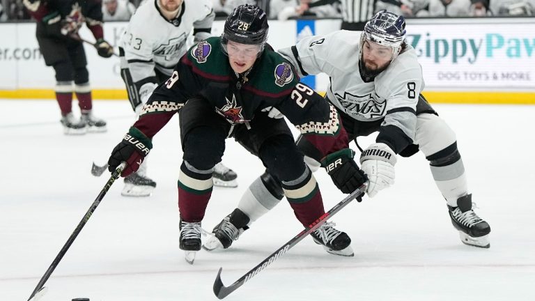 Los Angeles Kings defenseman Drew Doughty, right, tries to poke the puck away from Arizona Coyotes center Barrett Hayton during the first period of an NHL hockey game Saturday, Feb. 18, 2023, in Los Angeles. (Mark J. Terrill/AP)